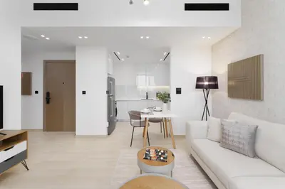 a living room with a white couch and a table at Luxury Living in 1 bedroom apartment in JVC in Dubai