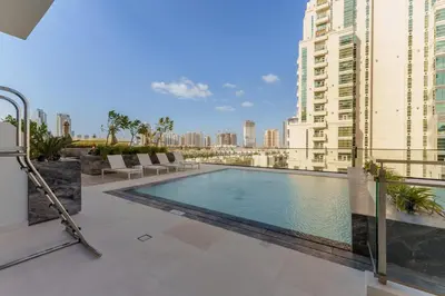 a swimming pool on the roof of a building at Luxury Living in 1 bedroom apartment in JVC in Dubai