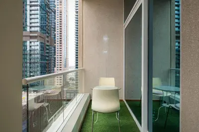 a balcony with a table and chairs in a building at 2 BR Marina View in Marina Heights By PK Holidays in Dubai