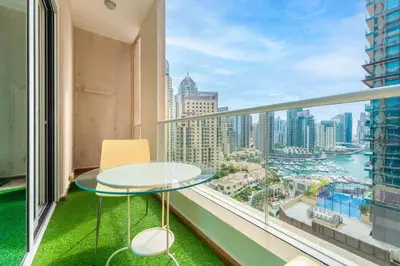 a balcony with a glass table and chairs and a view of the city at 2 BR Marina View in Marina Heights By PK Holidays in Dubai