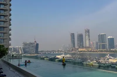 a group of people in the water in a city at Luxury beach house with mesmerizing skyline view in Dubai