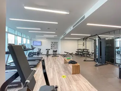 a gym with treadmills and exercise equipment in a building at Luxury beach house with mesmerizing skyline view in Dubai