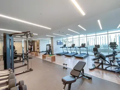a gym with treadmills and exercise equipment in a building at Luxury beach house with mesmerizing skyline view in Dubai
