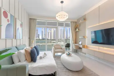a living room with a couch and a tv at Luxury beach house with mesmerizing skyline view in Dubai