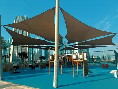 a playground with a large umbrella on a building at Downtown Views II Burj Khalifa View, Downtown Dubai - Mint Stay in Dubai