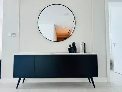 a black dresser with a mirror in a room at Luxury Brand New 2 Bhk Apartment In La Vie -jbr in Dubai