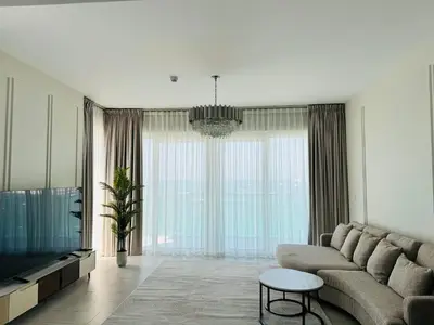 a living room with a couch and a tv at Luxury Brand New 2 Bhk Apartment In La Vie -jbr in Dubai