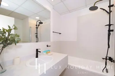 a bathroom with a sink and a mirror at LUX The Dubai Eye Sea View Suite in Dubai