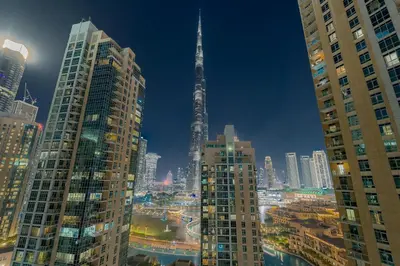 a view of a city at night with the spire at Astonishing 2 bedroom apt full Burj Khalifa view in Dubai