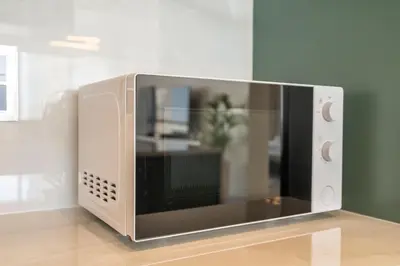 a microwave oven sitting on top of a table at Astonishing 2 bedroom apt full Burj Khalifa view in Dubai