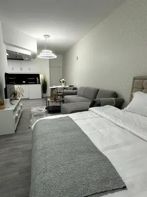 a bedroom with a bed and a living room at Dubai Marina - Huge Luxury Studio Apartment in Dubai