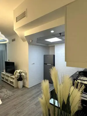 an office with a room with a refrigerator and plants at Dubai Marina - Huge Luxury Studio Apartment in Dubai
