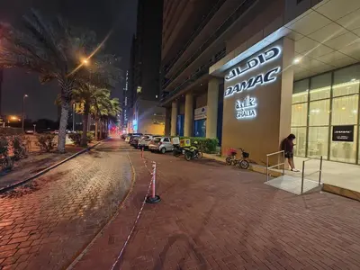 an empty street in front of a store at night at LeModCasa: Smart, modern studio in JVC in Dubai