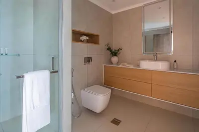 a bathroom with a toilet and a sink and a mirror at Frank Porter - Torch Tower in Dubai