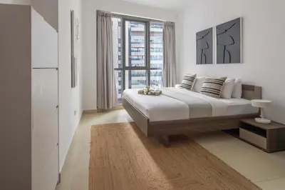 a bedroom with a large bed and a large window at Frank Porter - Torch Tower in Dubai