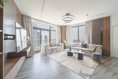 a living room with furniture and large windows at Frank Porter - Burj Views Central Tower in Dubai