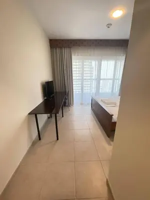 a bedroom with a desk and a bed and a window at Ensuite Rooms in CoLiving Apartments in Marina in Dubai