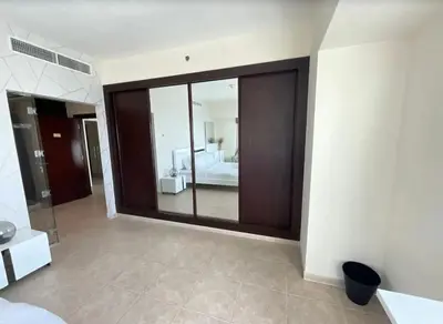 a bedroom with a large glass window with a bed at Ensuite Rooms in CoLiving Apartments in Marina in Dubai
