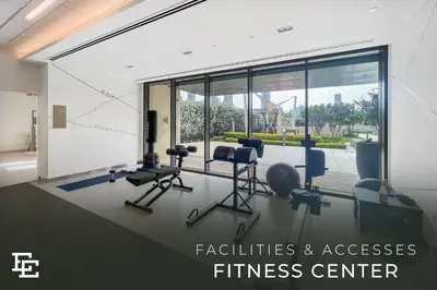an office with a fitness center with chairs and windows at Elite Escape Holiday Home - 2 BHK Getaway with Dubai Mall Access - 1503 in Dubai