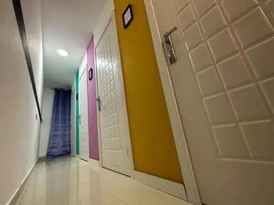 a hallway with doors painted different colors at Calm Partition Room Near Mashreq Metro in Dubai