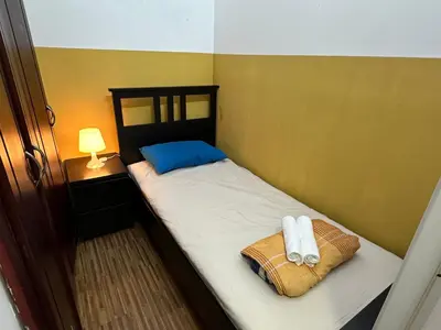 a small bedroom with a bed with towels on it at Prime Partition Room in Al Barsha 1 Near Metro in Dubai