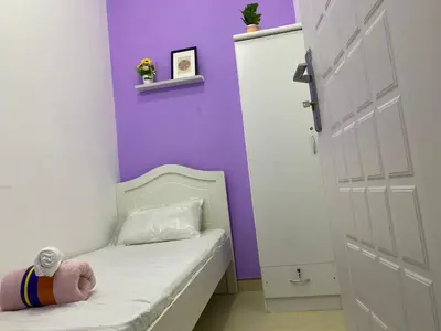 a childs room with a couch and a purple wall at Individual Partition Room in Al Barsha 1 Near Mashreq Metro in Dubai
