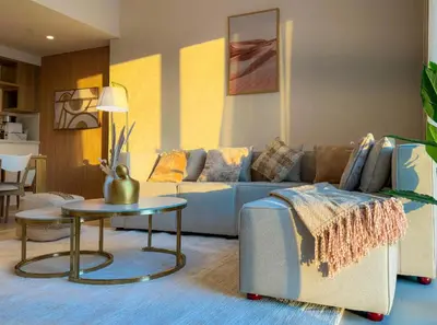 a living room with a couch and a table at Burj Khalifa view Lux 3 bedroom by Tanami Holiday Homes in Dubai