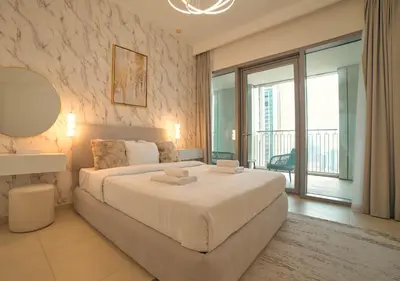 a bedroom with a large bed and a large window at Burj Khalifa view Lux 3 bedroom by Tanami Holiday Homes in Dubai