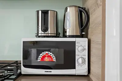 a microwave with a coffee pot on top of it at Summer offer! All Inclusive! Prime Location in Dubai