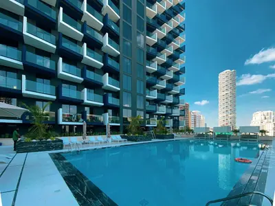 a large swimming pool in front of a building at Spacious Balcony, King Bed, Pool at JVC Dubai in Dubai