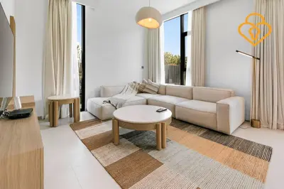 a living room with a couch and a table at Keysplease Wonderful 4 B/R Home with Garden Arabian Ranches in Dubai