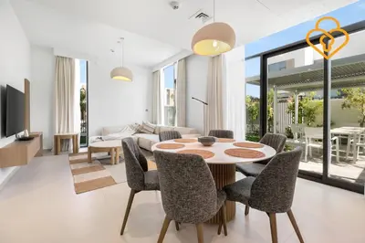 a living room with a table and chairs at Keysplease Wonderful 4 B/R Home with Garden Arabian Ranches in Dubai