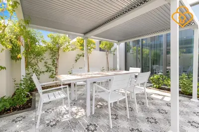 a white table and chairs on a patio at Keysplease Wonderful 4 B/R Home with Garden Arabian Ranches in Dubai