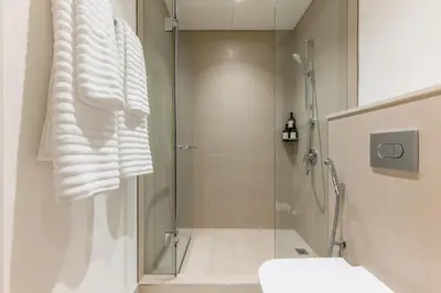 a bathroom with a shower with a glass door at Stunning 2 Bedroom Apartment with Burj Views by Zen Stays - Walking Distance to Dubai Mall in Dubai