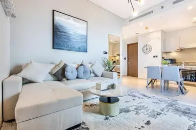 a living room with a couch and a table at STAY BY LATINEM Luxury 1BR Holiday Home CVR A2504 near Burj Khalifa in Dubai