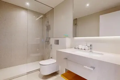 a bathroom with a toilet and a sink and a shower at La Vie, JBR - Spacious One Bedroom in Dubai