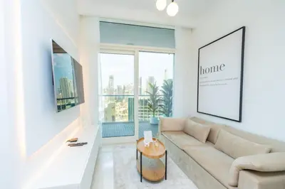 a living room with a couch and a large window at The Dreamer 1BR Burj Khalifa View Business Bay in Dubai