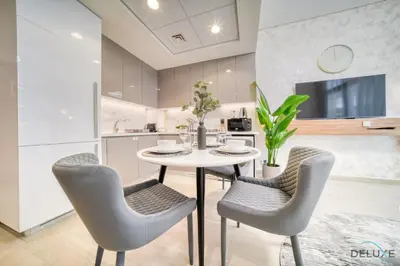a kitchen and dining room with a table and chairs at Serene 1BR Apartment in Azizi Riviera 27, Al Merkadh by Deluxe Holiday Homes in Dubai