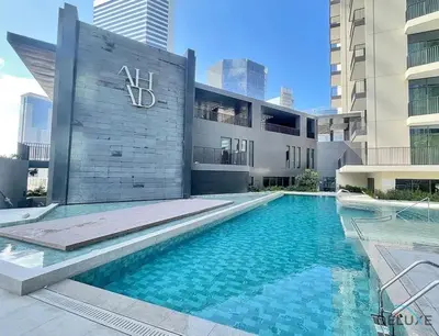 a swimming pool in front of a building at Welcoming 1BR Apartment in Ahad Residences Business Bay by Deluxe Holiday Homes in Dubai