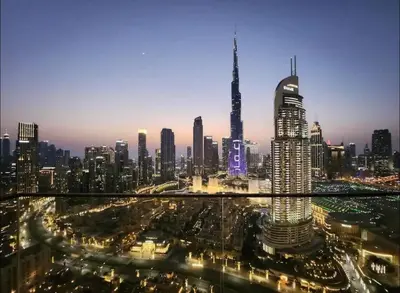 a view of a large city at night at **Panoramic Views Of Burj Khalifa and Fountain** in Dubai