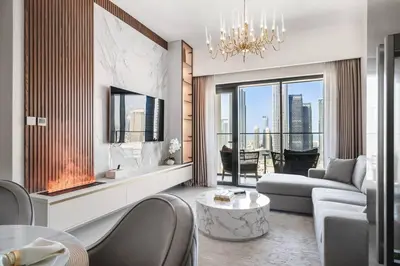 a living room with a couch and a chandelier at **Panoramic Views Of Burj Khalifa and Fountain** in Dubai