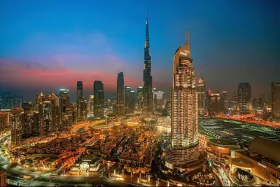 a view of a large city at night at *Views of Burj Khalifa Fountain* in Dubai