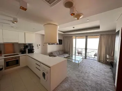 a kitchen and living room with a couch and a table at Suitestay-Formerly Address Dubai Mall Residence-Downtown in Dubai