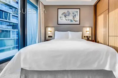 a bedroom with a large white bed and a window at Address Residences Dubai Opera, Downtown Dubai in Dubai