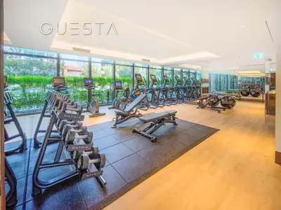 a gym with a row of treadmills and machines at Address Residences Dubai Opera, Downtown Dubai in Dubai