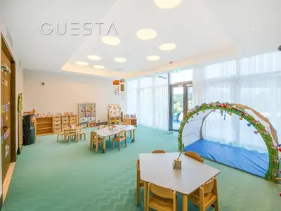 a kindergarten classroom with tables and chairs and an arch at Address Residences Dubai Opera, Downtown Dubai in Dubai