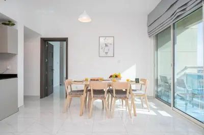 a dining room with a table and chairs at Budget Friendly Production City in Dubai