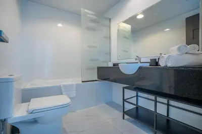 a white bathroom with a sink and a toilet at Budget Friendly Production City in Dubai