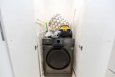 a washing machine with a toy on top of it at FAM Living - Modern 3 Beds+Maidroom Home in Downtown Burj view in Dubai