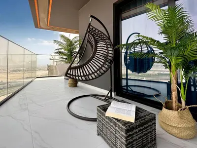 a room with a plant and a book on a table at Serene City Stays Binghatti Canal Luxe 2BR in Dubai